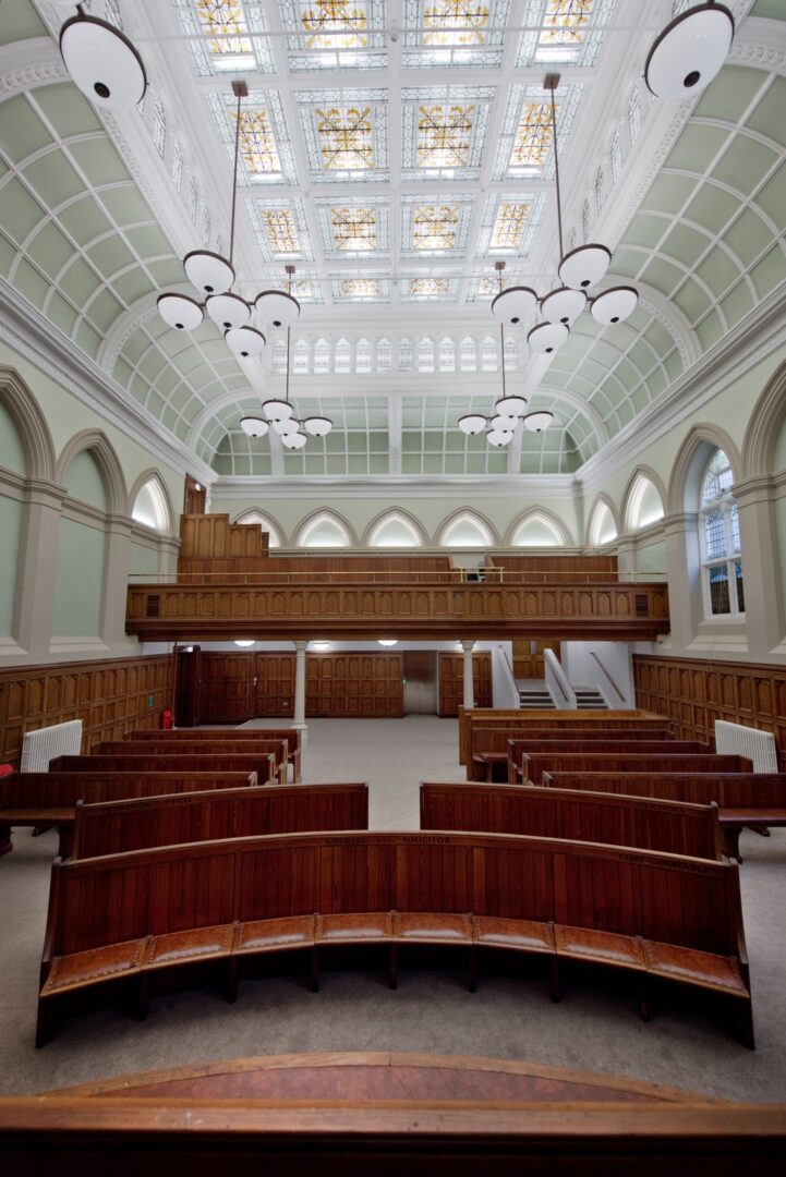 view of the courtroom seating and ceiling the front of the room