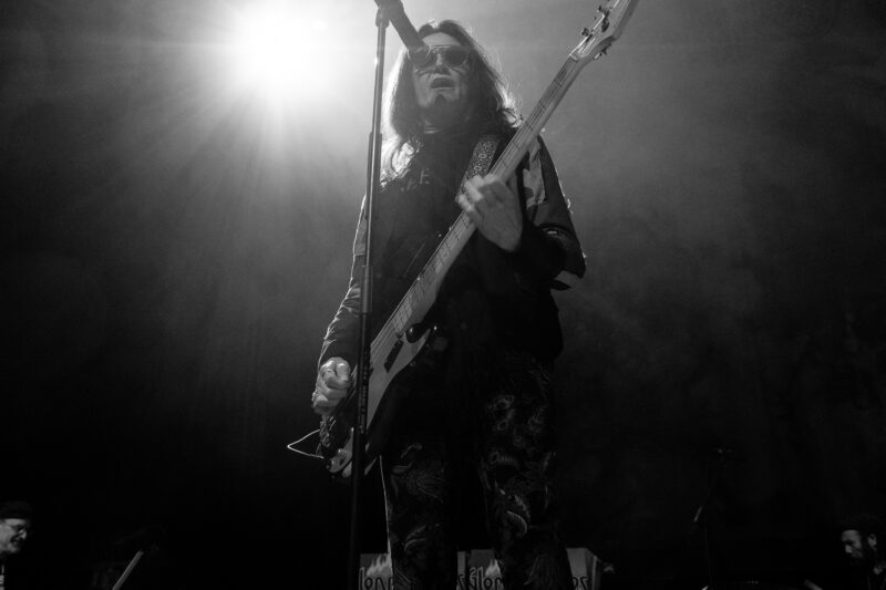 black and white image of Glenn Hughes performing on stage