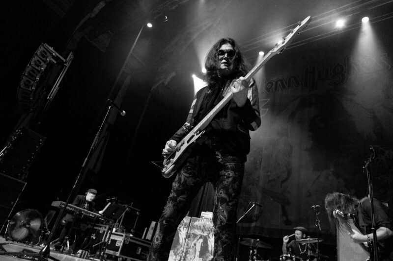 black and white image of Glenn Hughes performing on stage